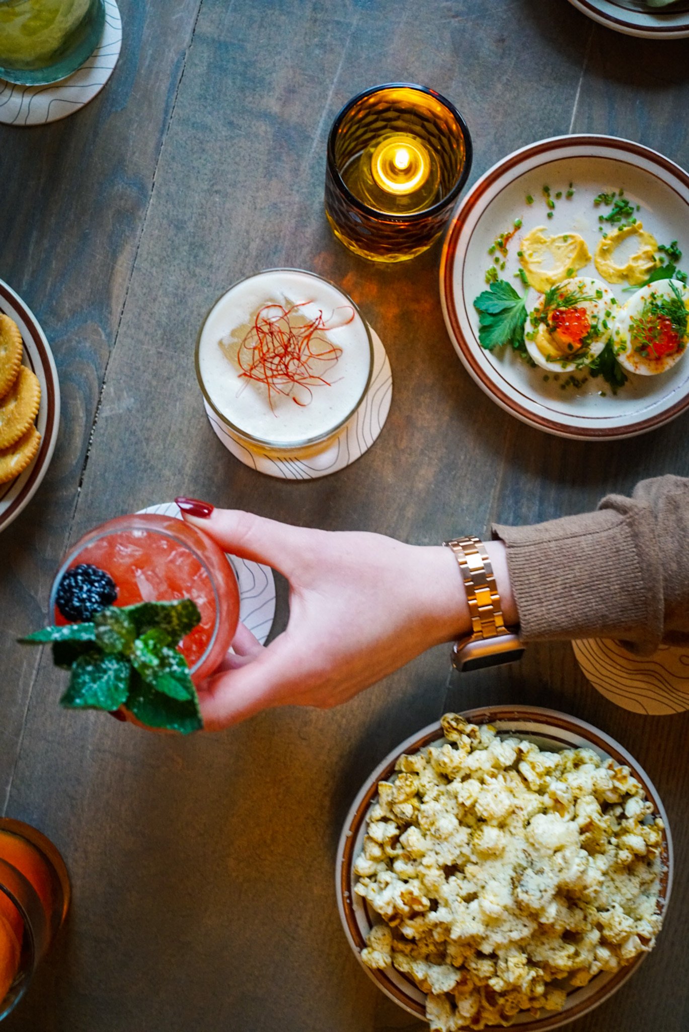 Cocktails shared across a warmly lit bar